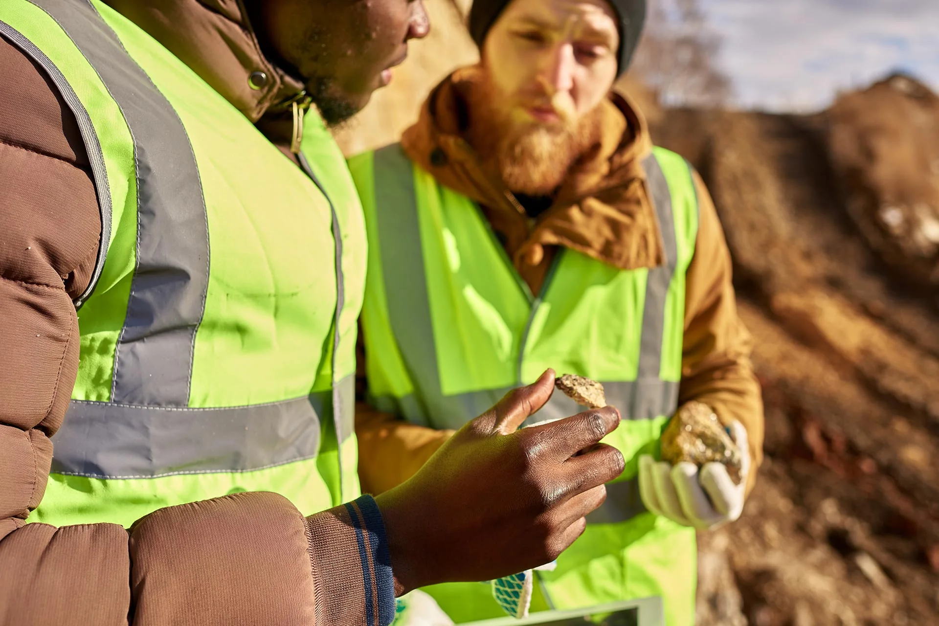 Geologists examining ore samples in the field